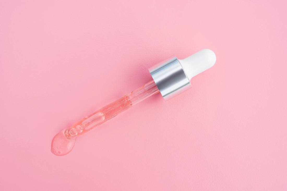 Pink serum dropper on a pink background